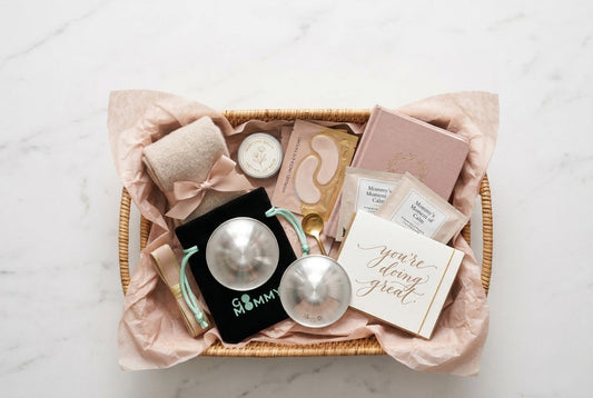 Gift basket for new mom with silver nursing cups, water bottle, snacks, and self-care items